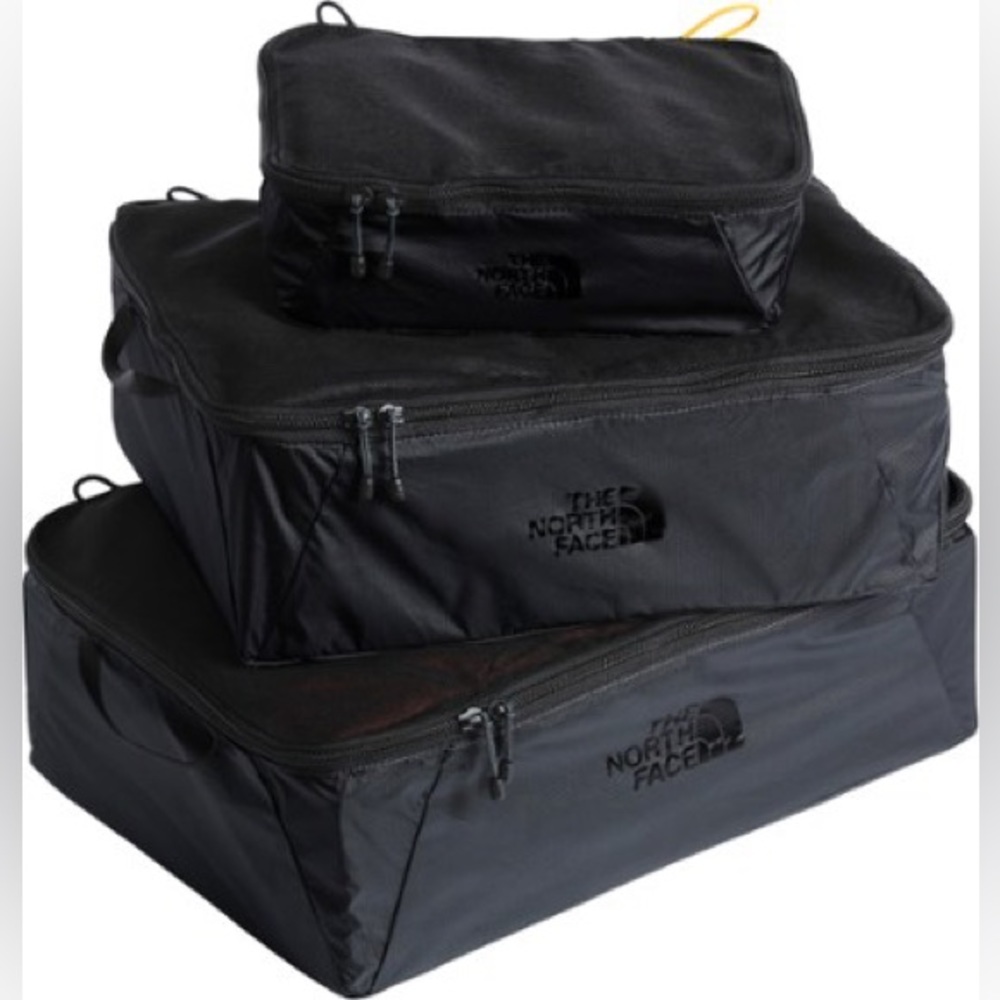 Listed upon request. Lot of three The North Face flyweight cubes.